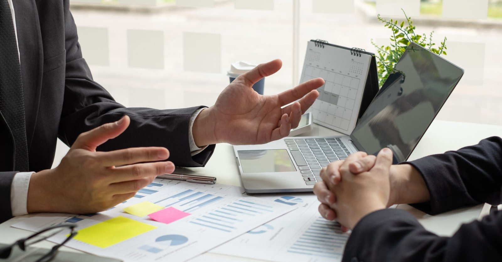 business leaders talk about charts, financial graphs showing res
